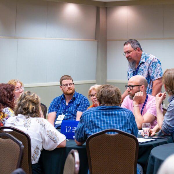 Group of members gathered around a table